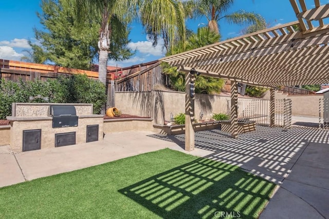 view of patio with exterior kitchen, a fenced backyard, a grill, and a pergola