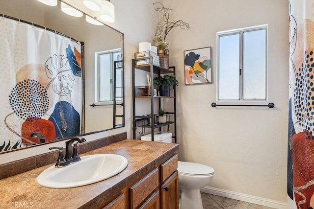 bathroom with curtained shower, toilet, vanity, tile patterned flooring, and baseboards