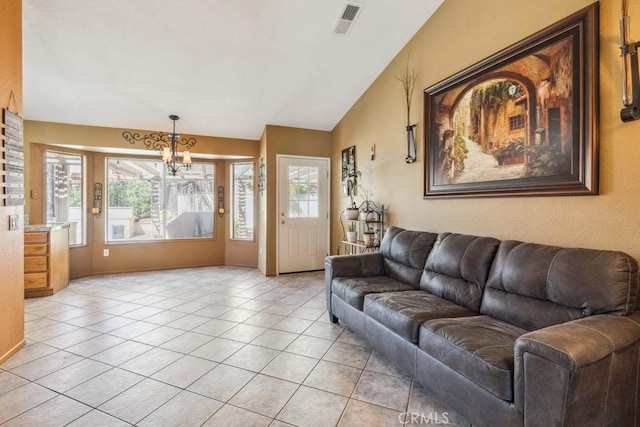 living area with lofted ceiling, light tile patterned floors, visible vents, and a chandelier