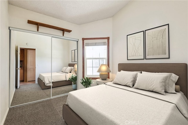 bedroom with a closet, carpet flooring, vaulted ceiling, and a textured ceiling