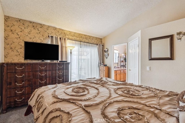 bedroom with lofted ceiling, ensuite bathroom, a textured ceiling, and carpet flooring