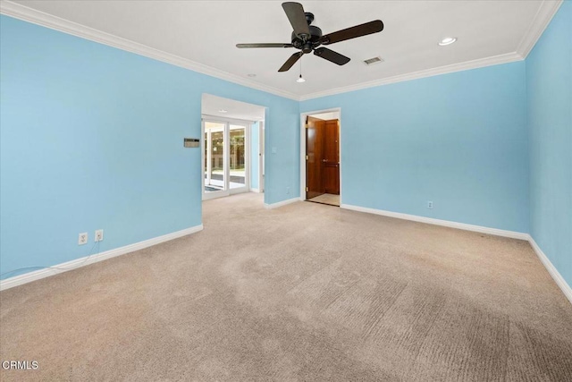 spare room featuring baseboards, ornamental molding, and light colored carpet