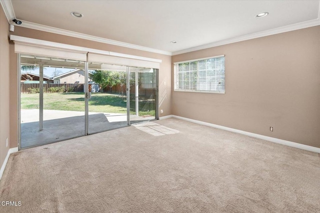 carpeted empty room featuring recessed lighting, a healthy amount of sunlight, crown molding, and baseboards