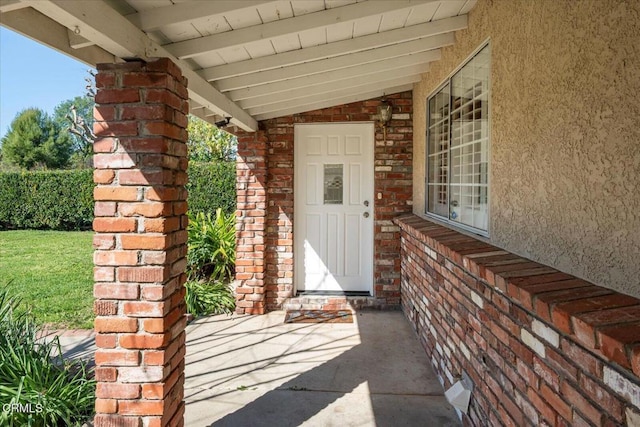 entrance to property with stucco siding and brick siding