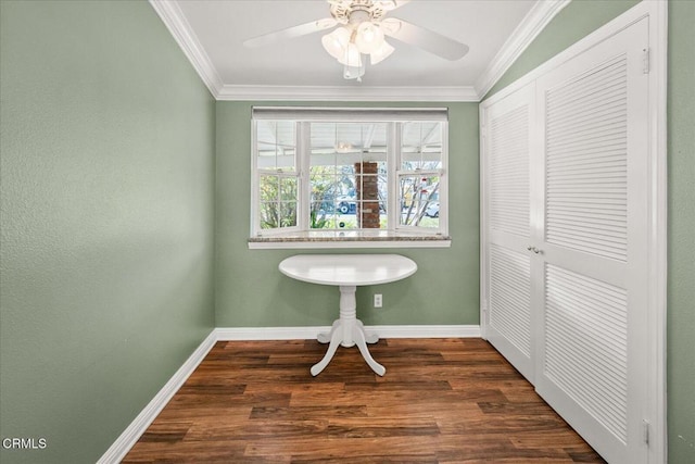 interior space featuring ornamental molding, a ceiling fan, baseboards, and wood finished floors