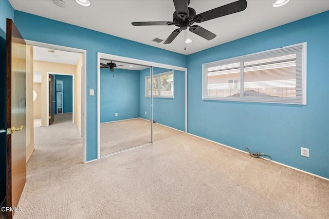 unfurnished bedroom featuring recessed lighting, visible vents, a ceiling fan, a closet, and carpet