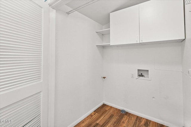 laundry room featuring dark wood-style floors, cabinet space, hookup for a washing machine, and baseboards