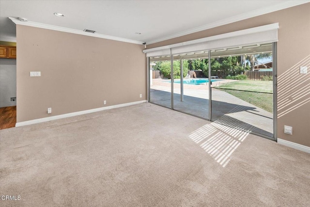 empty room featuring baseboards, recessed lighting, carpet, and crown molding