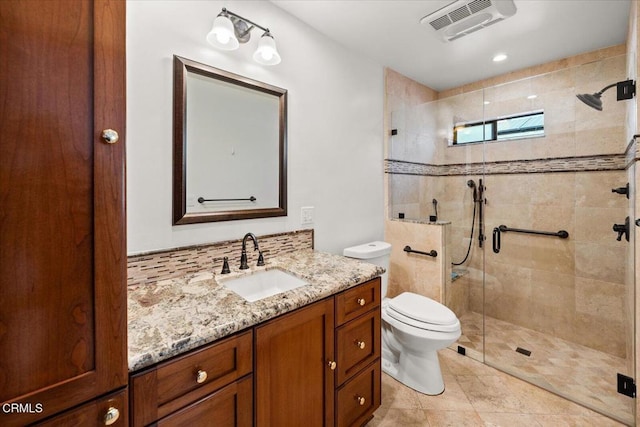 full bathroom featuring toilet, a shower stall, visible vents, and vanity