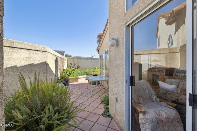 view of patio / terrace featuring fence