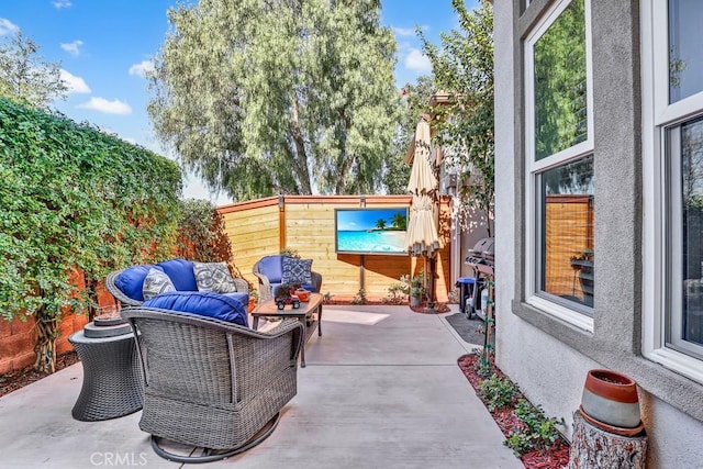 view of patio / terrace featuring an outdoor hangout area and fence