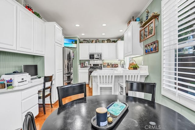 dining area featuring recessed lighting and light wood finished floors