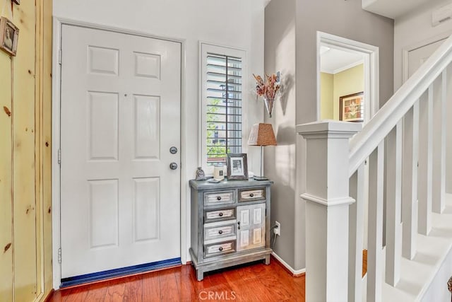 foyer featuring stairs and wood finished floors