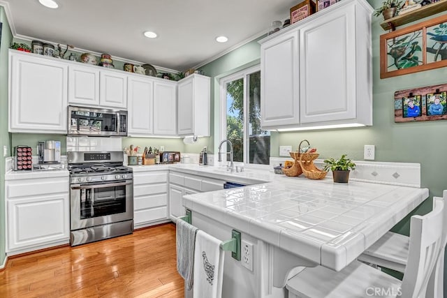 5 Ash Hollow Trl, Ladera Ranch, CA 92694 - kitchen featuring stainless steel appliances, tile counters, white cabinetry, a sink, and recessed lighting