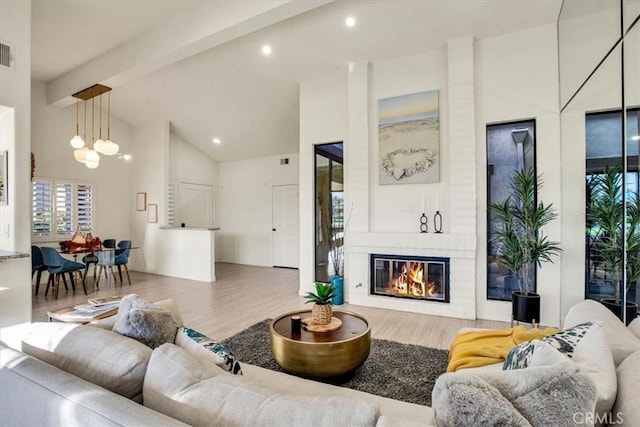 31 Blue River Dr, Palm Desert, CA 92211 - living room with wood finished floors, a large fireplace, beamed ceiling, recessed lighting, and high vaulted ceiling