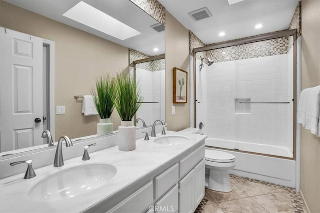 31 Blue River Dr, Palm Desert, CA 92211 - full bathroom featuring a skylight, tile patterned flooring, double vanity, toilet, and shower / bath combination with glass door