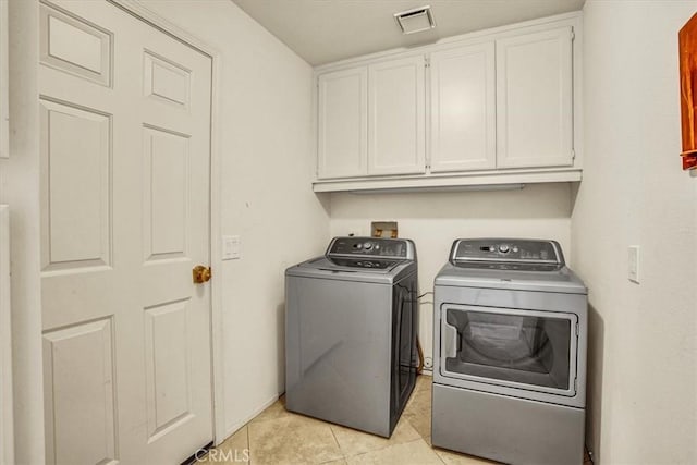 31 Blue River Dr, Palm Desert, CA 92211 - washroom featuring cabinet space, washer and clothes dryer, and light tile patterned floors