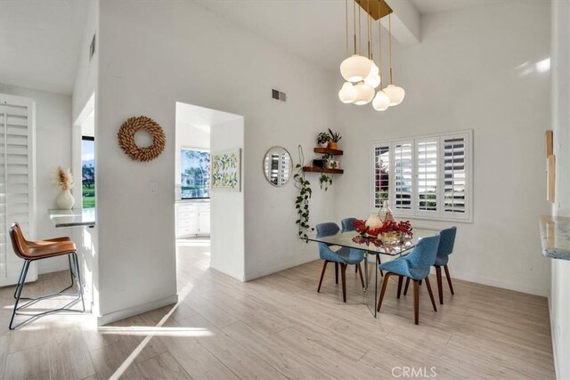 31 Blue River Dr, Palm Desert, CA 92211 - dining space featuring high vaulted ceiling, light wood-style flooring, and baseboards