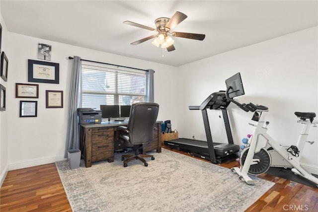 home office featuring ceiling fan, baseboards, and wood finished floors