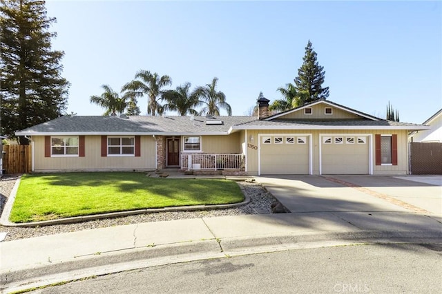 single story home with a garage, fence, concrete driveway, and a front yard