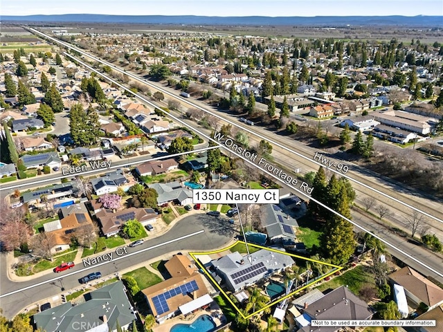 drone / aerial view featuring a residential view and a mountain view