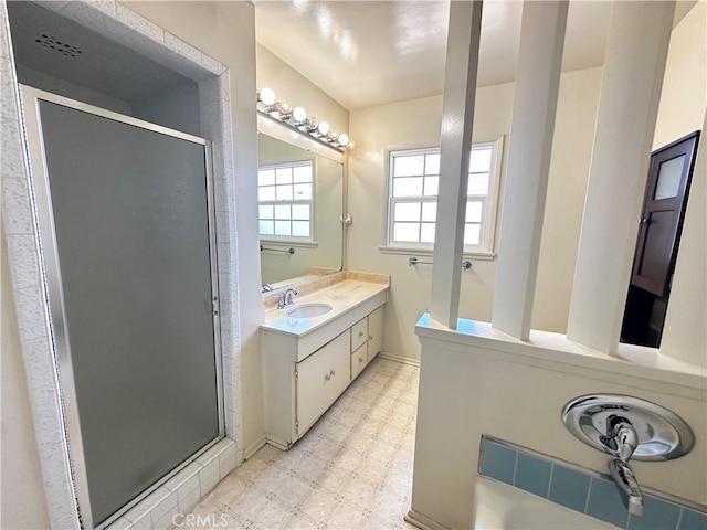 full bathroom with a shower stall, vanity, and tile patterned floors