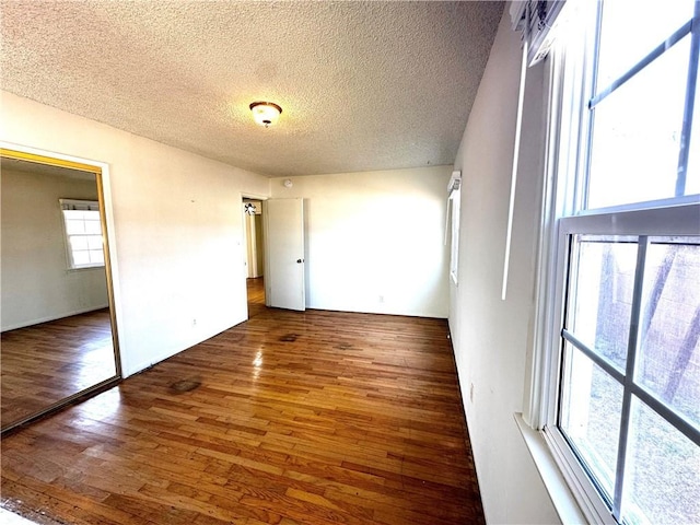 unfurnished bedroom with a textured ceiling and hardwood / wood-style floors