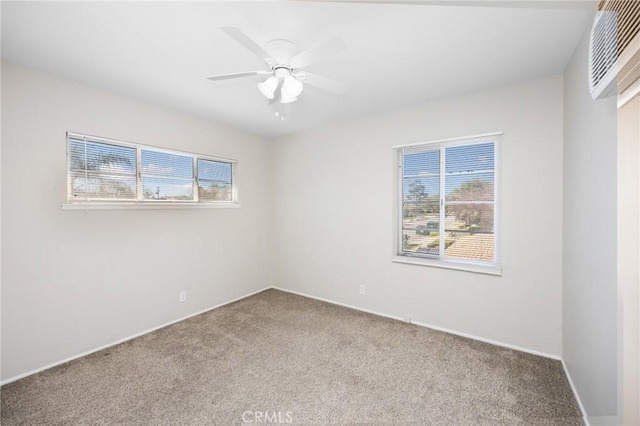 spare room featuring carpet floors and a ceiling fan