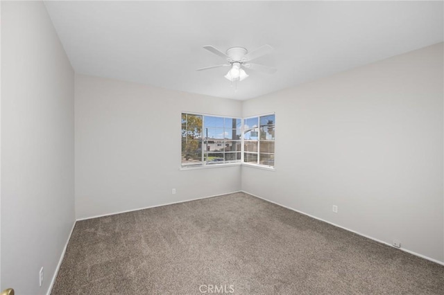 spare room with carpet and a ceiling fan