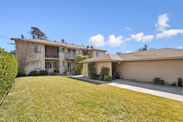 view of front of property with a front lawn and stucco siding