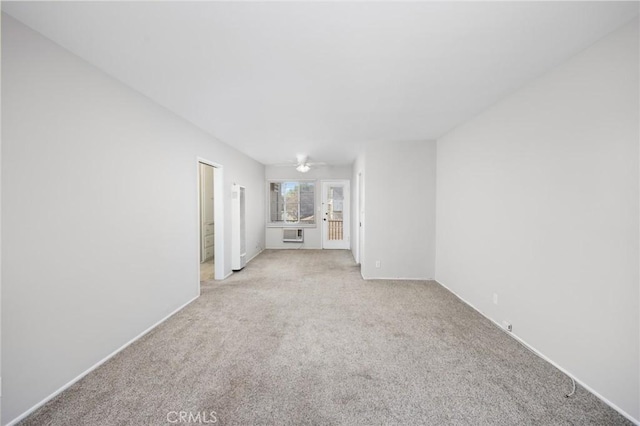 unfurnished living room featuring light carpet and a ceiling fan