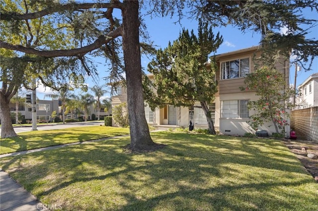 view of front of property featuring a front yard, a residential view, and stucco siding