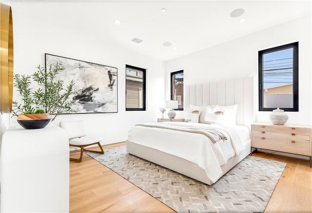 bedroom featuring recessed lighting, visible vents, and light wood-style floors