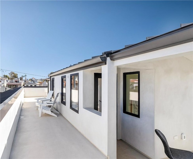 view of home's exterior with a balcony and stucco siding