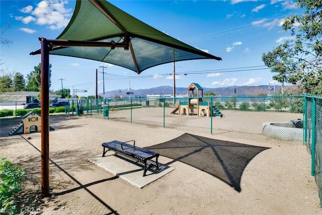 community playground with fence and a mountain view