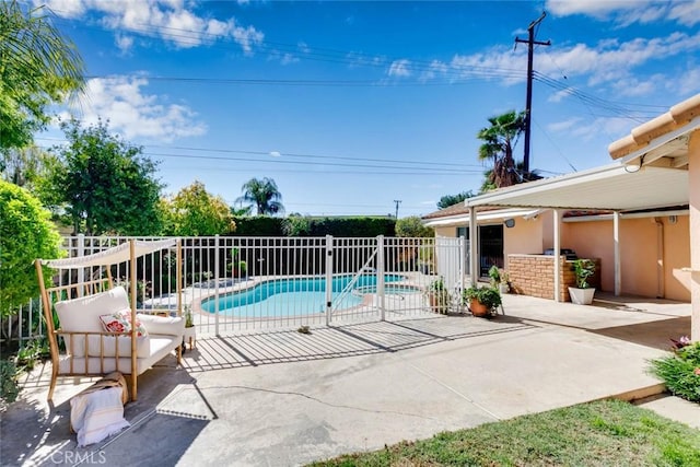 view of swimming pool featuring a patio, fence, and a fenced in pool