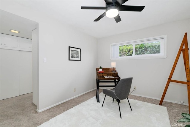 carpeted office featuring baseboards