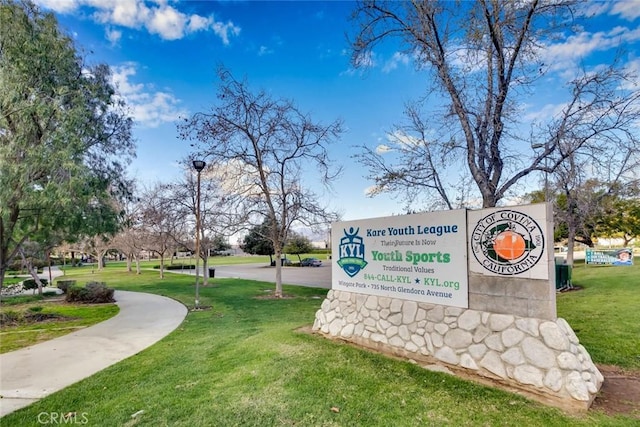 view of home's community with a yard