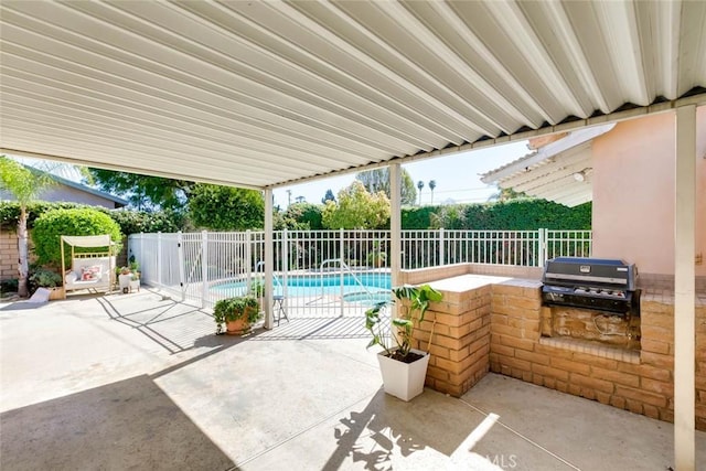 view of patio / terrace featuring exterior kitchen, a fenced in pool, a fenced backyard, and area for grilling