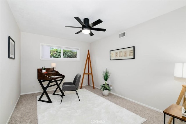 office featuring carpet floors, baseboards, visible vents, and a ceiling fan