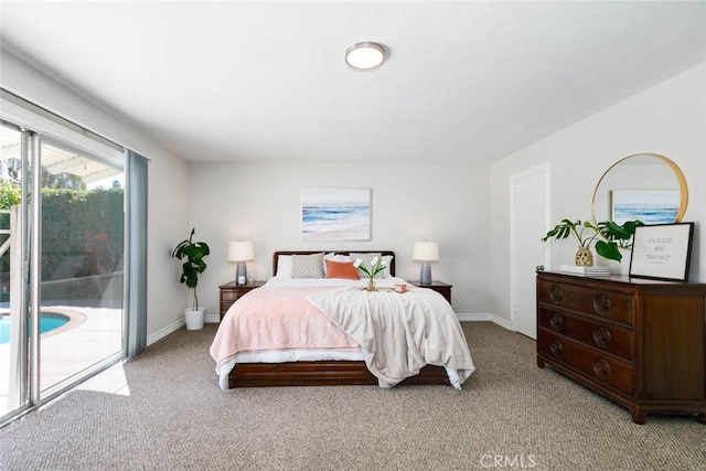 bedroom with access to outside, light colored carpet, and baseboards