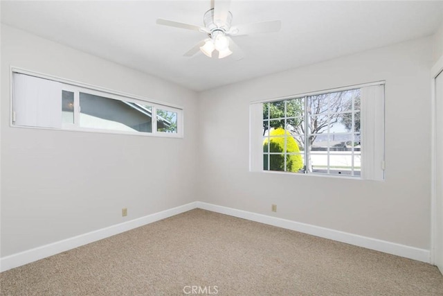 unfurnished room featuring baseboards, carpet floors, and a healthy amount of sunlight