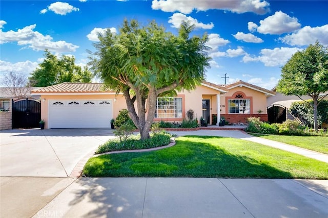 single story home featuring stucco siding, an attached garage, a front yard, a gate, and driveway