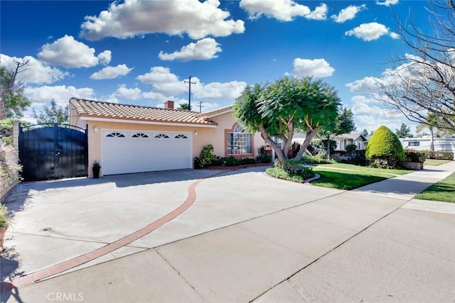 view of front facade with a tile roof, a chimney, stucco siding, concrete driveway, and an attached garage