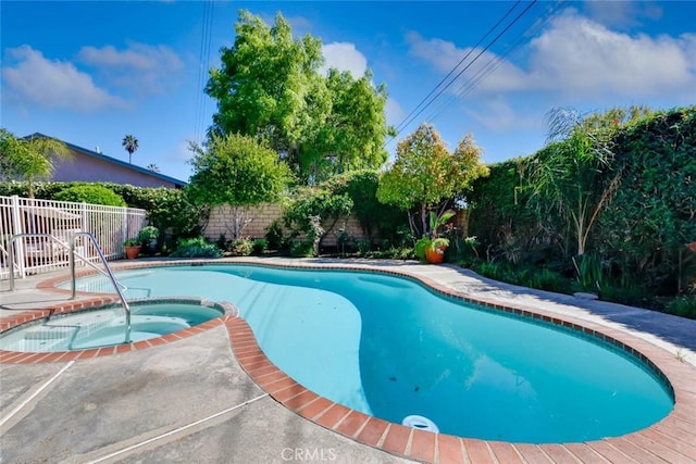 view of swimming pool featuring a fenced backyard and a pool with connected hot tub