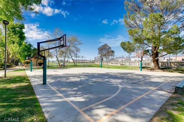 view of basketball court with community basketball court and fence