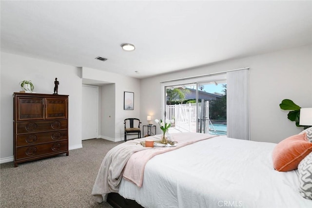 carpeted bedroom featuring baseboards, visible vents, and access to exterior