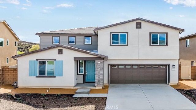 view of front of home featuring stucco siding, fence, driveway, and a tiled roof