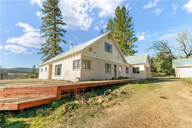 back of property with a wooden deck