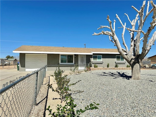 single story home with concrete driveway, fence, an attached garage, and stucco siding